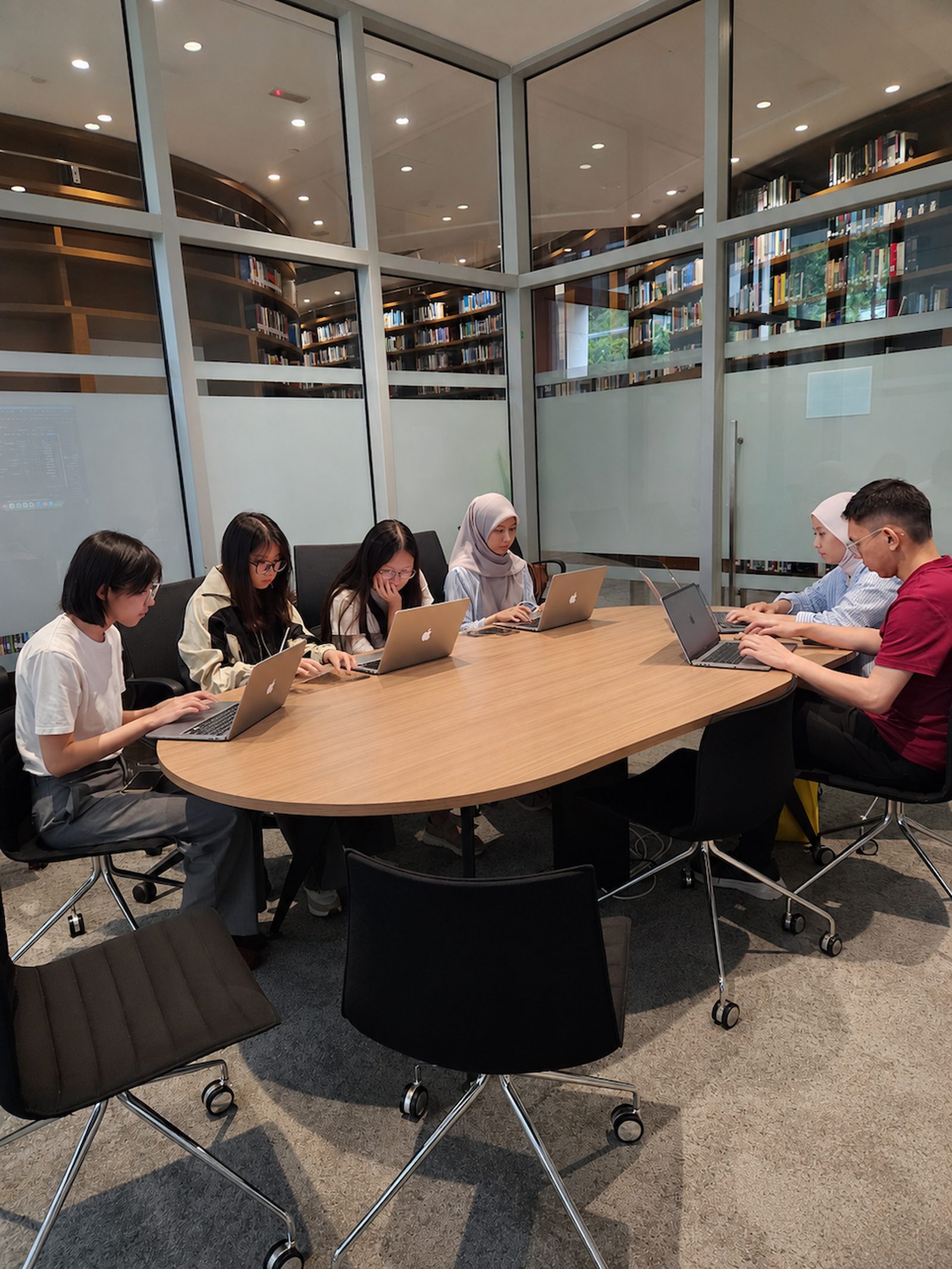 Prima Nexus team members working and learning together
