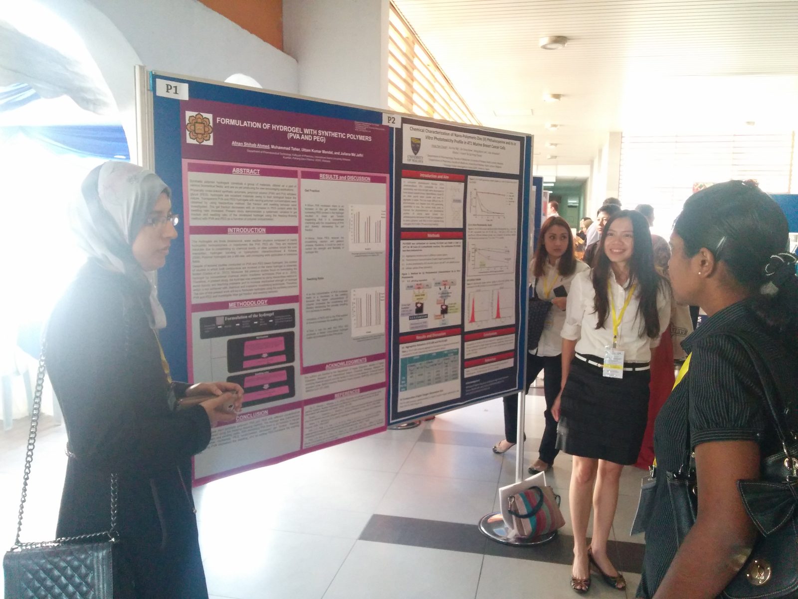 Delegates talk in front of research posters during the poster session