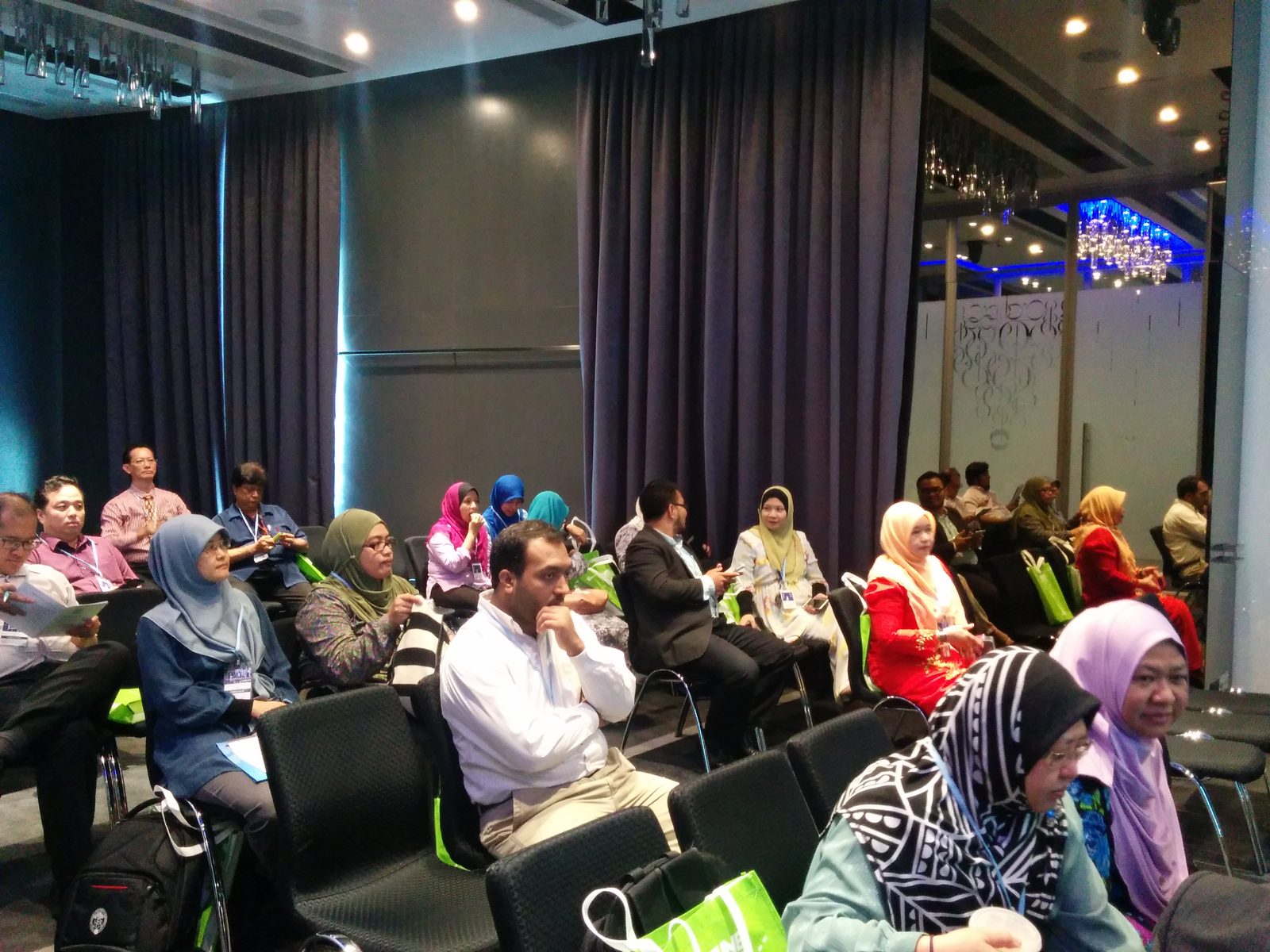 Participants seated in rows listening in the seminar room