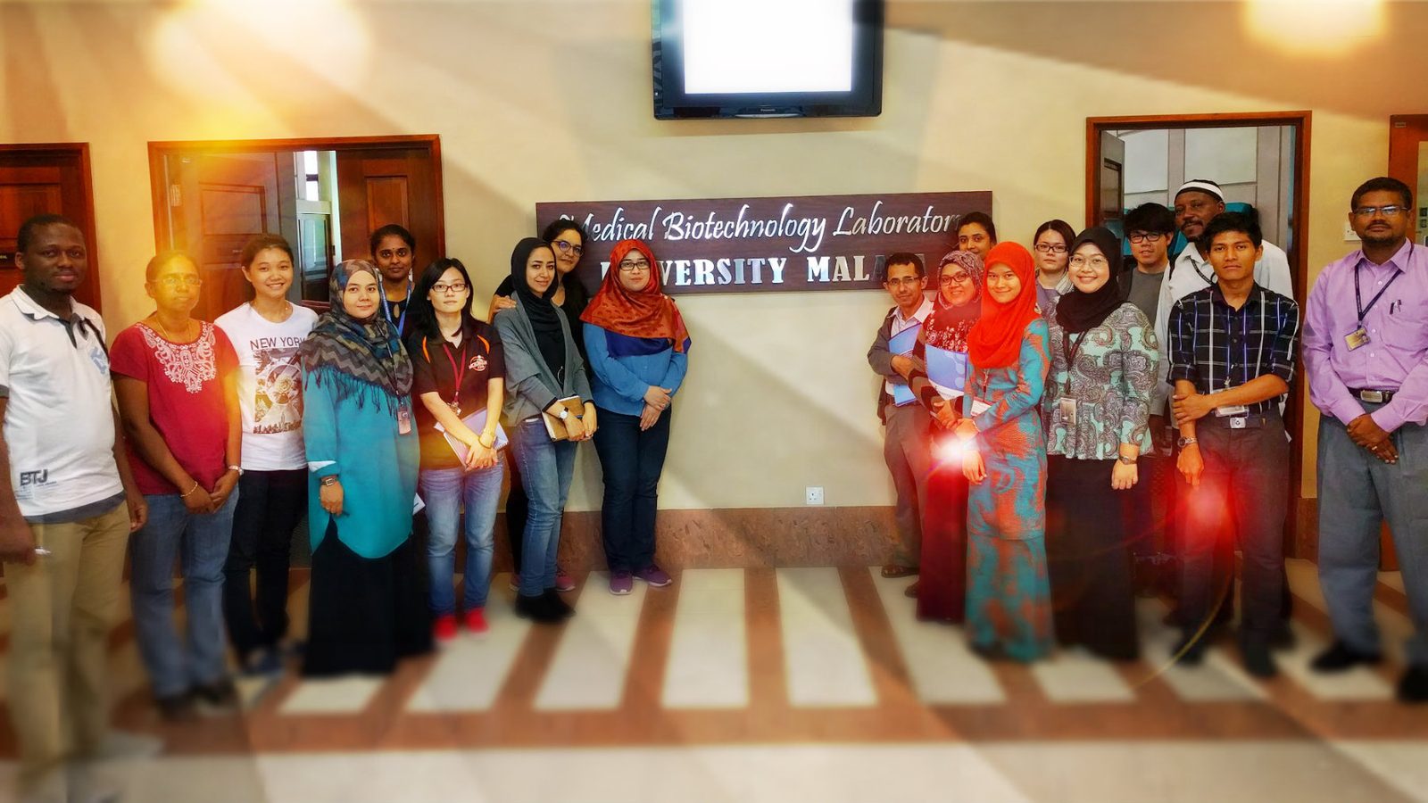 Workshop group photo under the Medical Biotechnology Laboratory sign at Universiti Malaya