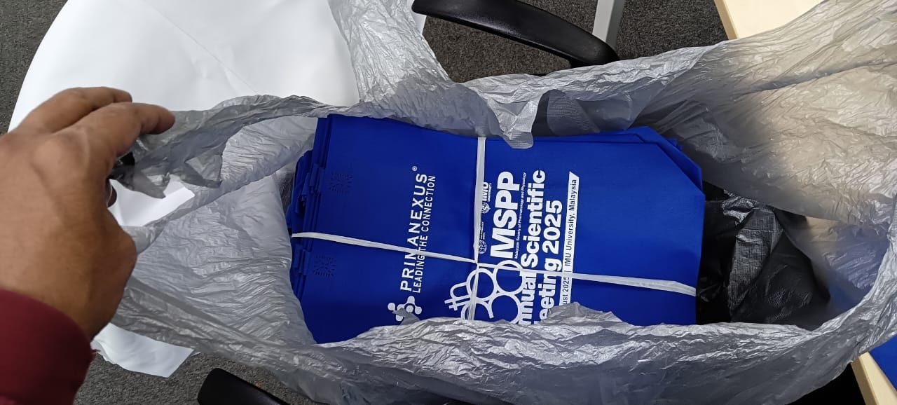 A stack of blue Prima Nexus and MSPP conference bags packed inside a plastic bag