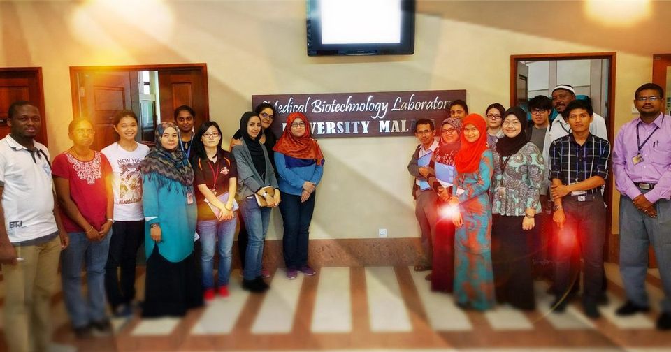 Workshop group photo under the Medical Biotechnology Laboratory sign at Universiti Malaya