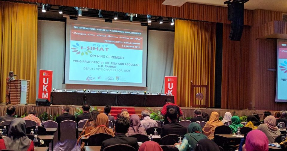 Delegates seated at rows of tables facing the stage and screen during the iSIHAT 2017 opening ceremony