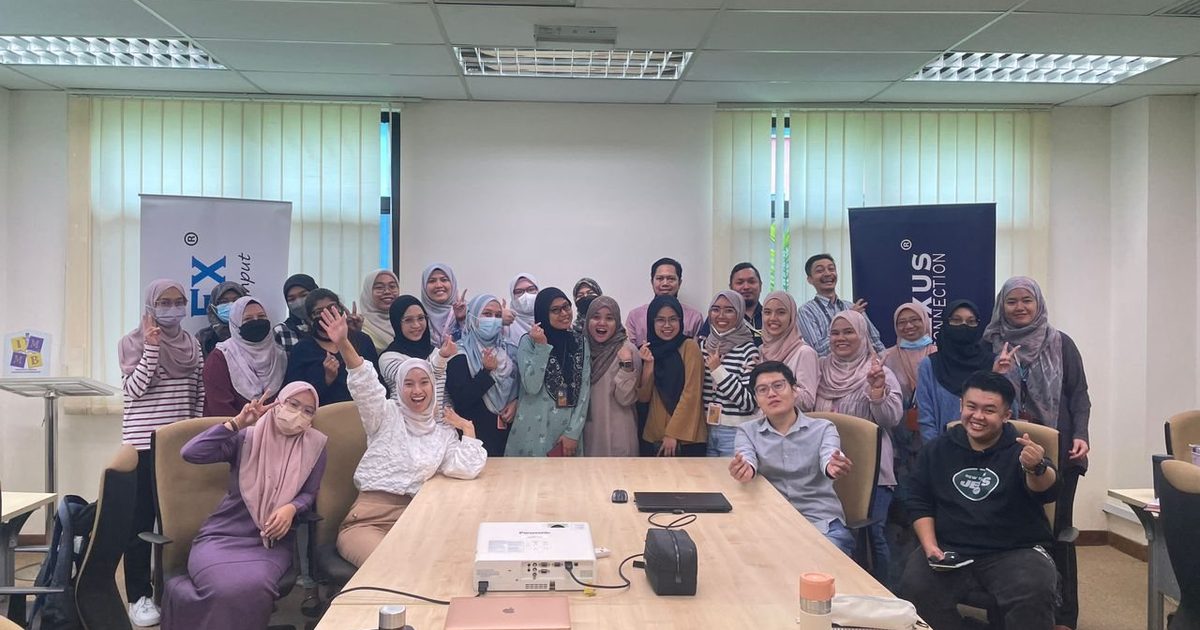 Workshop participants and the Prima Nexus team in a group photo in a meeting room at IMMB