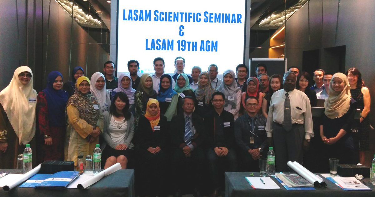 Group photo of participants in front of a screen reading LASAM Scientific Seminar and LASAM 19th AGM