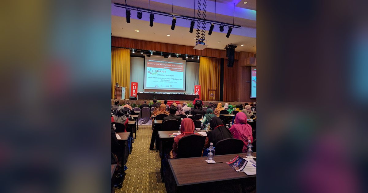 Delegates seated at rows of tables facing the stage and screen during the iSIHAT 2017 opening ceremony