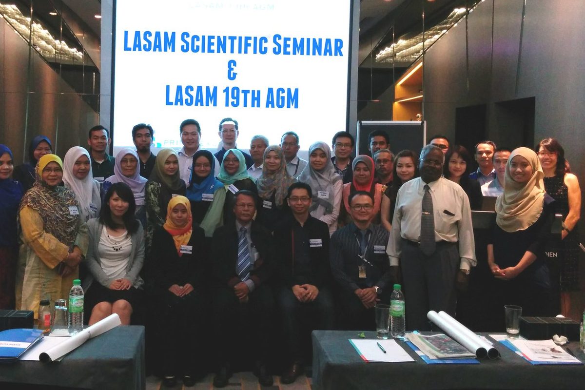 Group photo of participants in front of a screen reading LASAM Scientific Seminar and LASAM 19th AGM