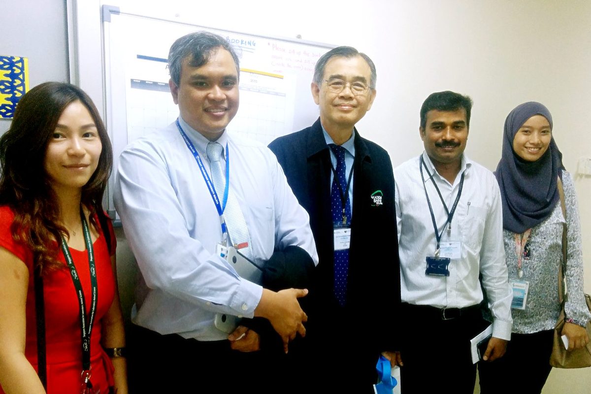 Five people taking part in the stem cell programme stand together for a photo in a corridor