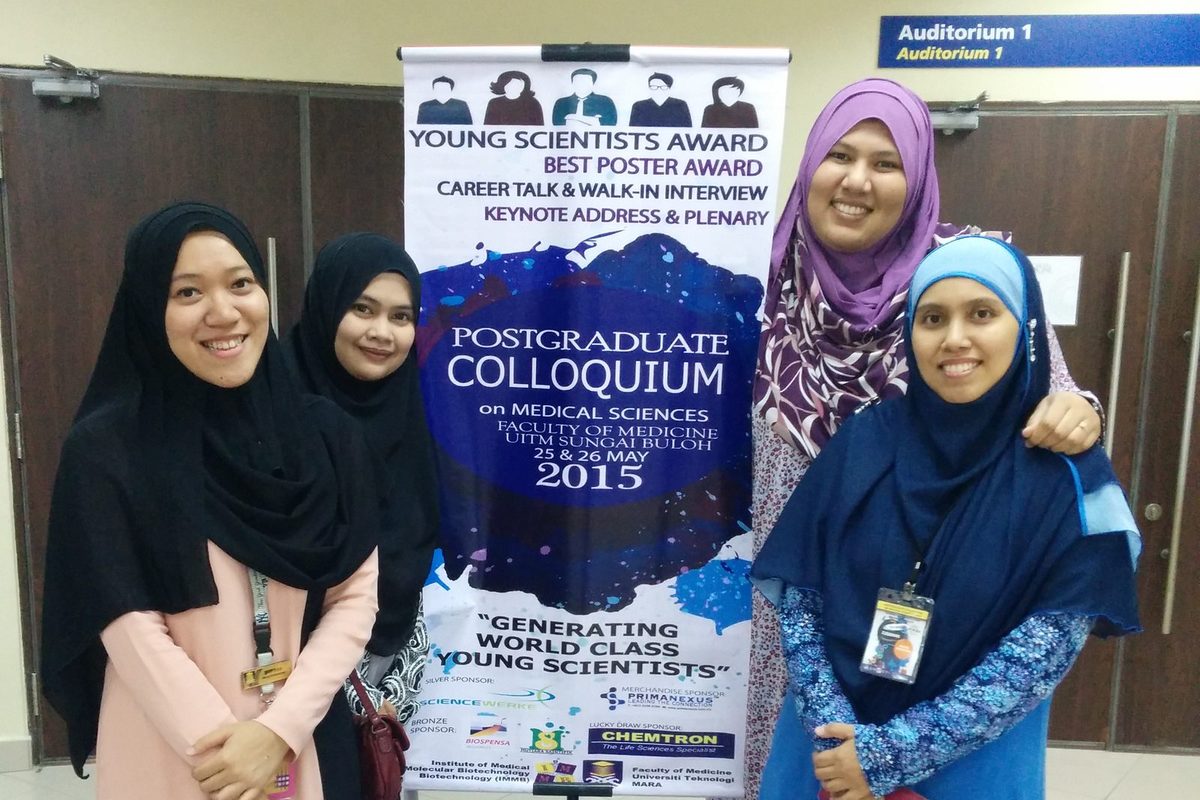 Four participants stand together at PCOMS 2015.