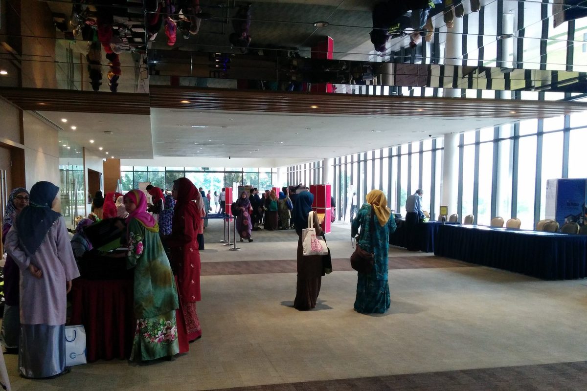 Delegates gathering in the convention centre foyer beside the exhibition tables