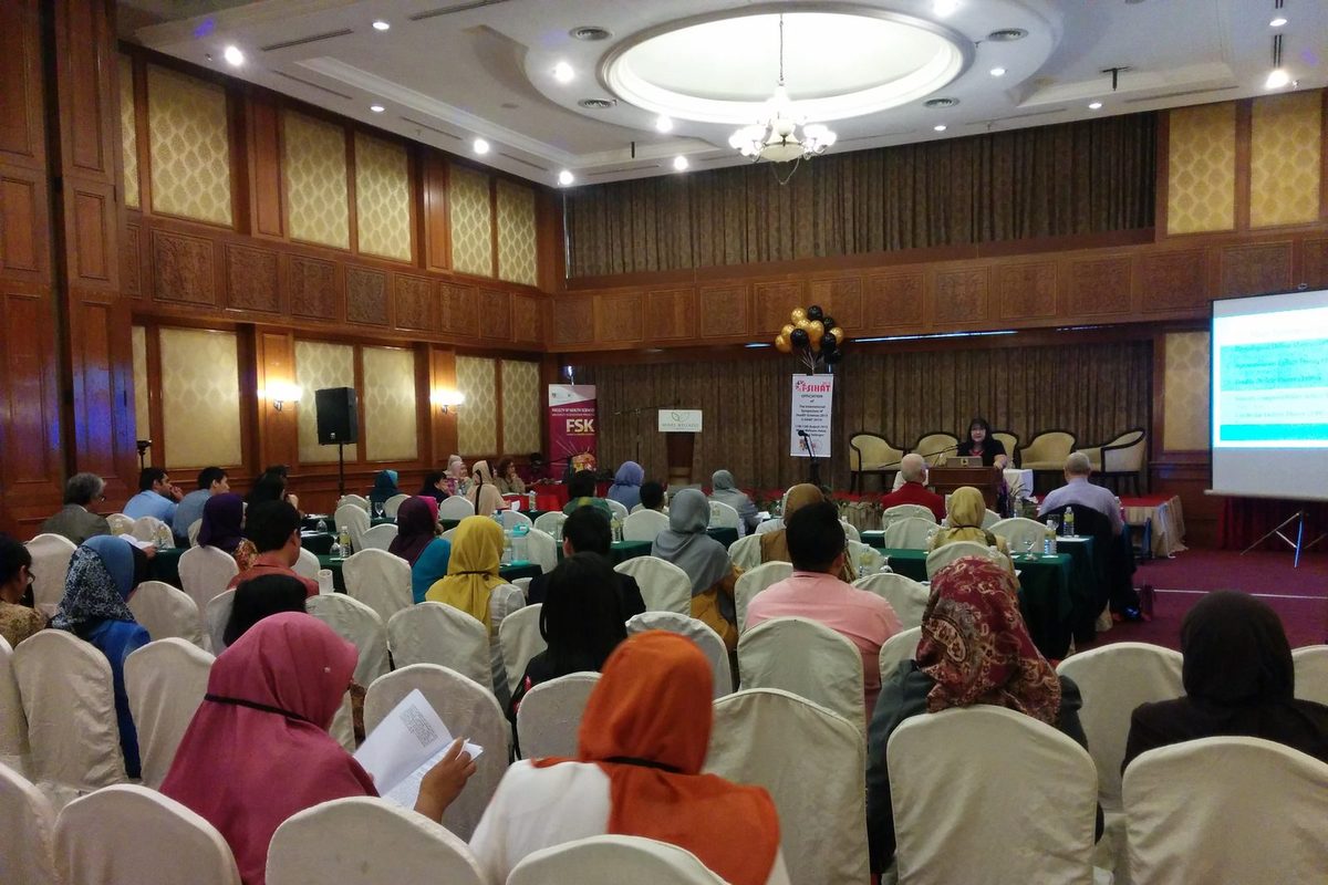 Delegates seated in the main hall facing a speaker at the lectern