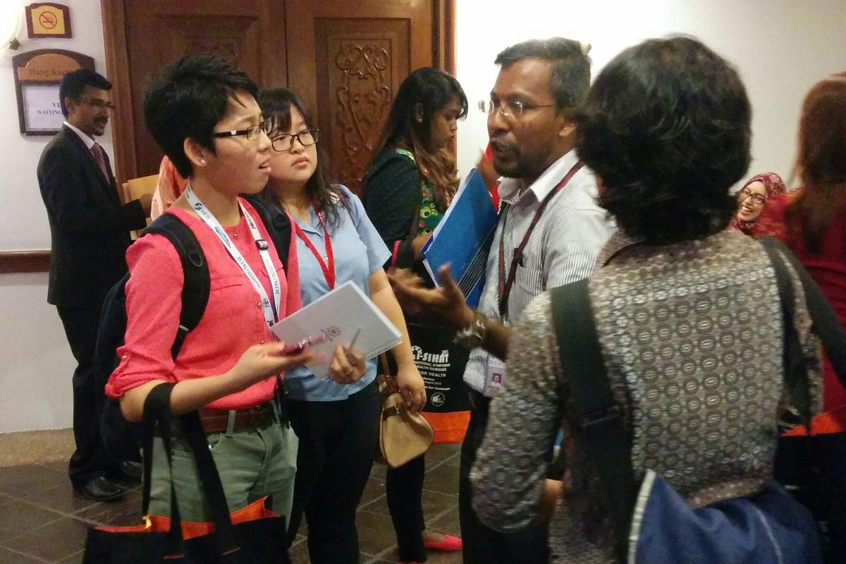 Delegates talk together in the hotel corridor between sessions
