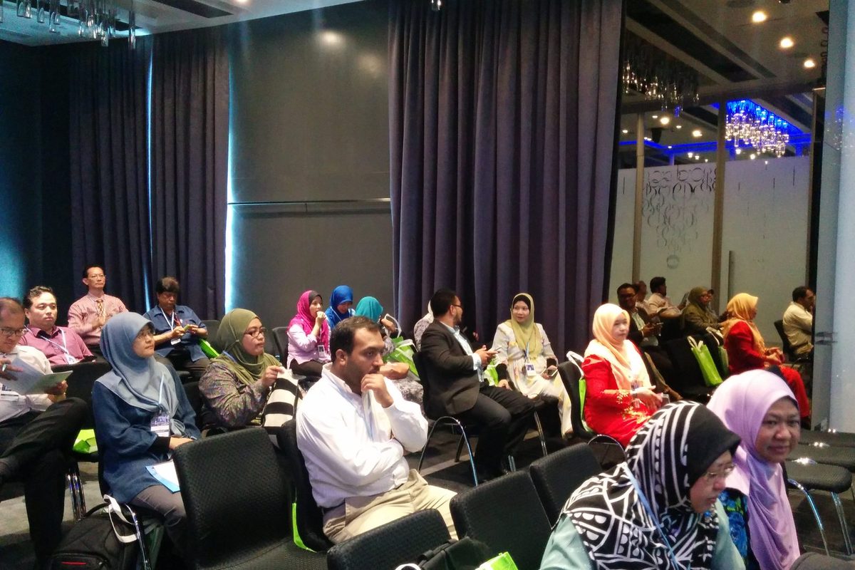 Participants seated in rows listening in the seminar room