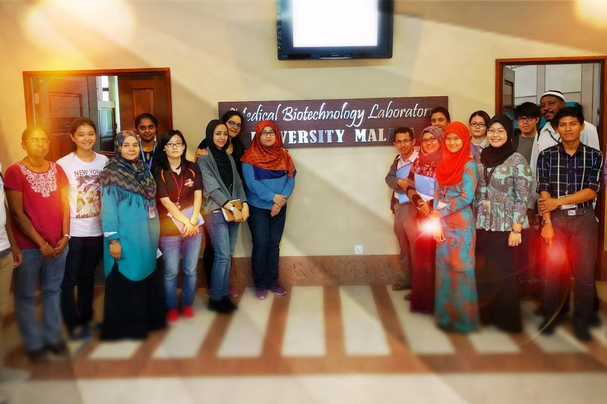 Workshop group photo under the Medical Biotechnology Laboratory sign at Universiti Malaya