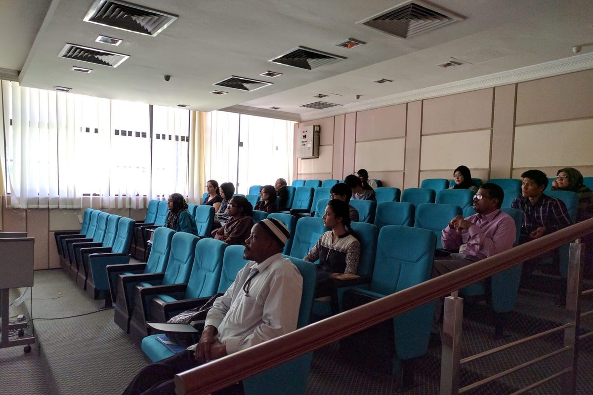 Participants seated in a tiered seminar room during the workshop talk