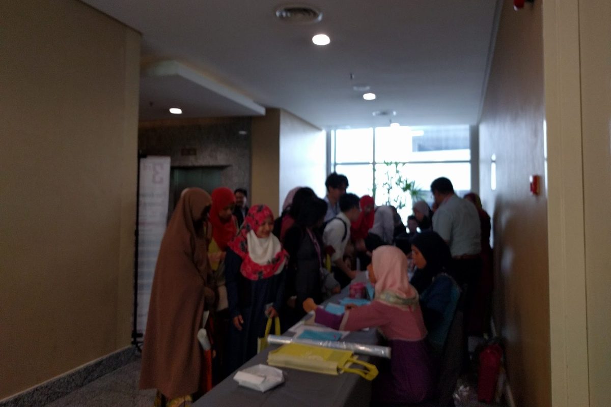 Delegates crowding around a table in a corridor outside the conference halls