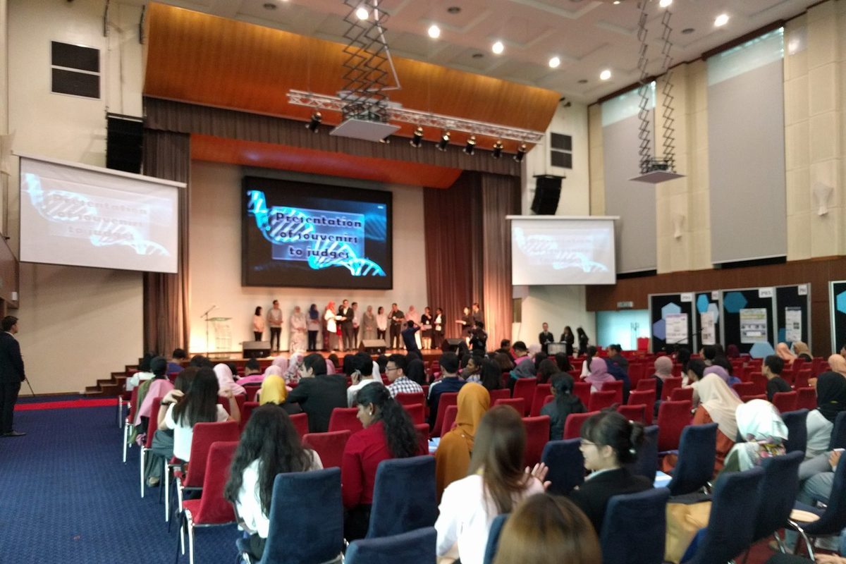 Wide view of the ballroom and stage as souvenirs are presented to the judges