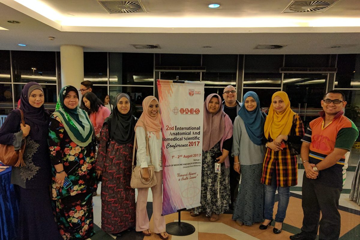 A group of delegates standing beside the IABS2017 conference banner