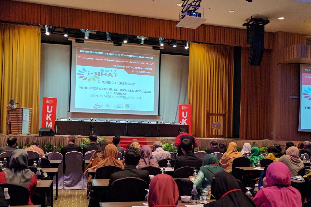 Delegates seated at rows of tables facing the stage and screen during the iSIHAT 2017 opening ceremony