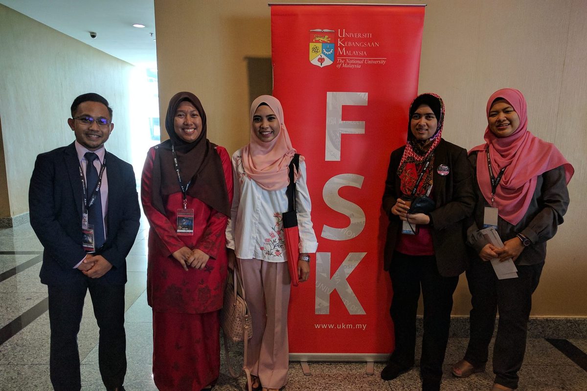 Five people stand beside a red UKM Faculty of Health Sciences (FSK) banner