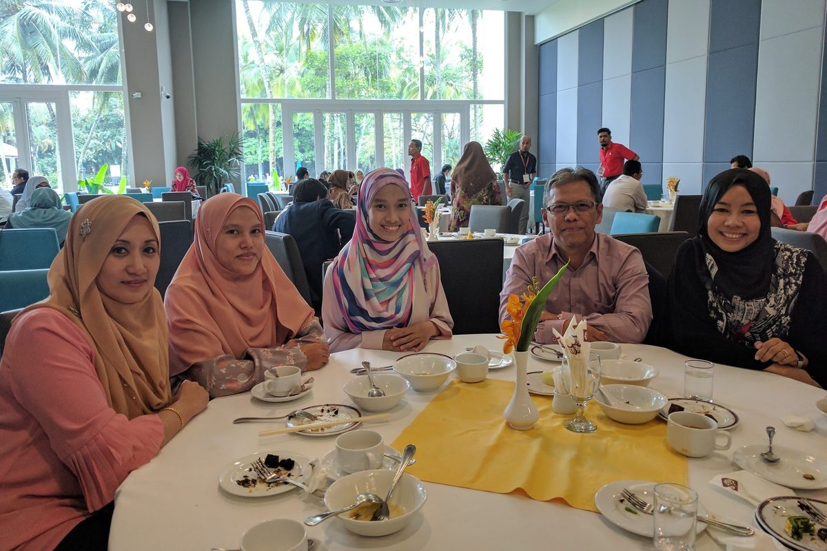 Guests seated at a round table in the hotel’s dining hall