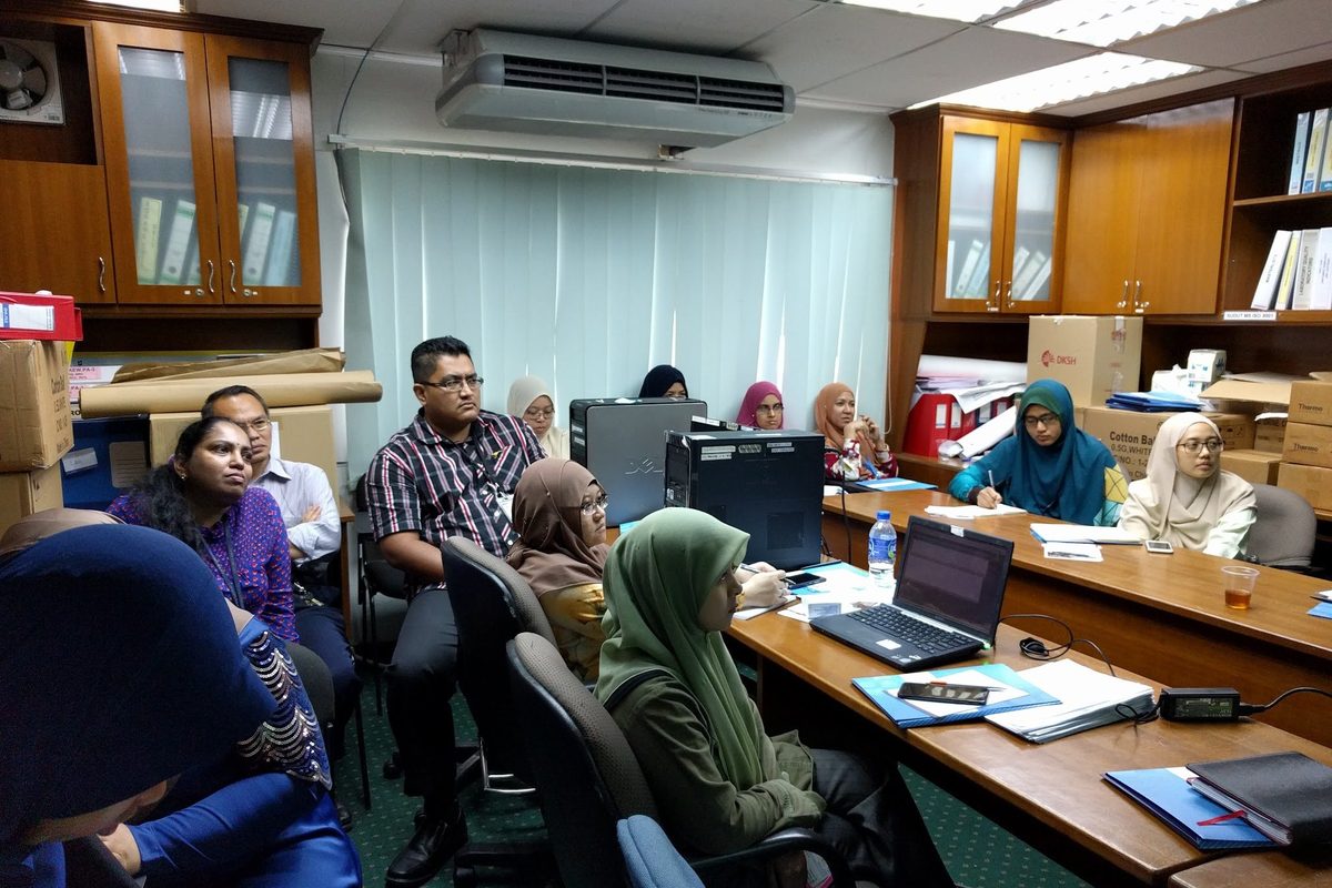 Participants seated around the room listening to a talk