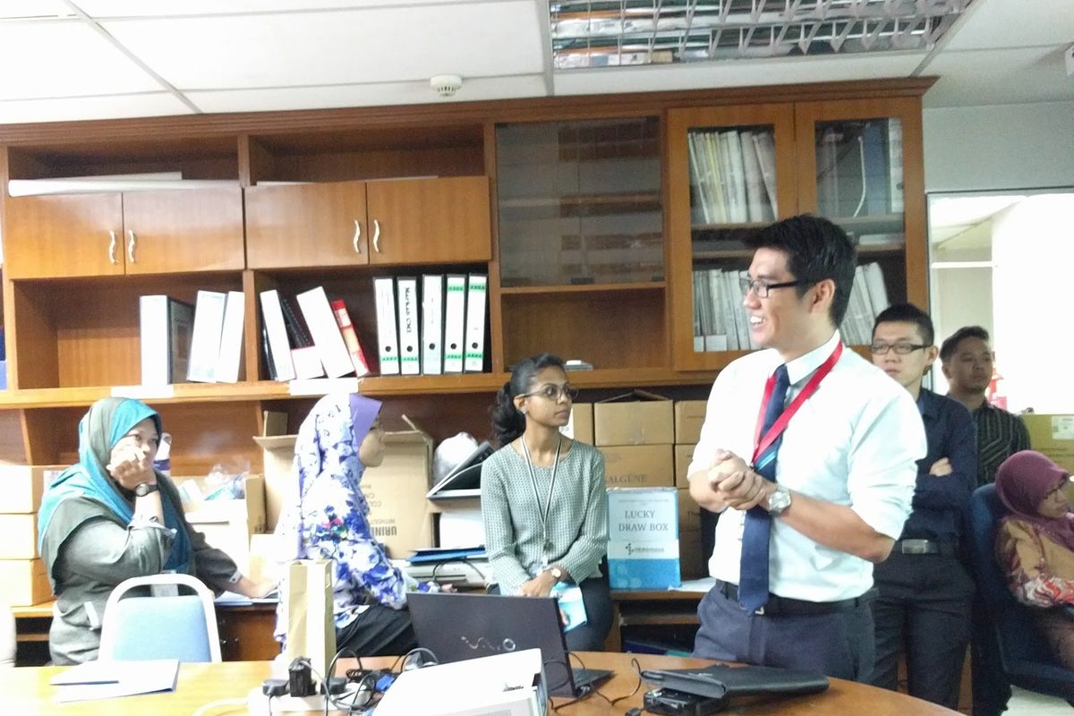 A speaker addresses the participants from the front of the room