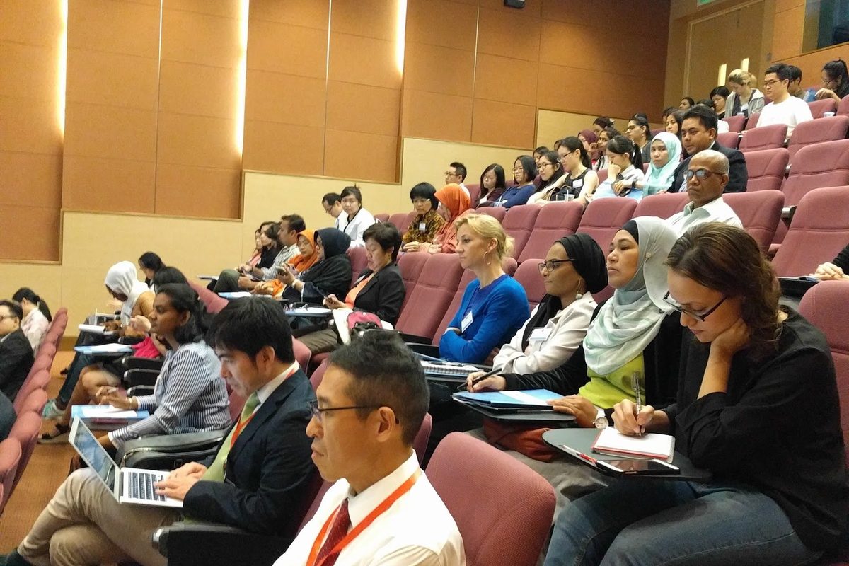 Delegates seated in the tiered Plenary Theatre