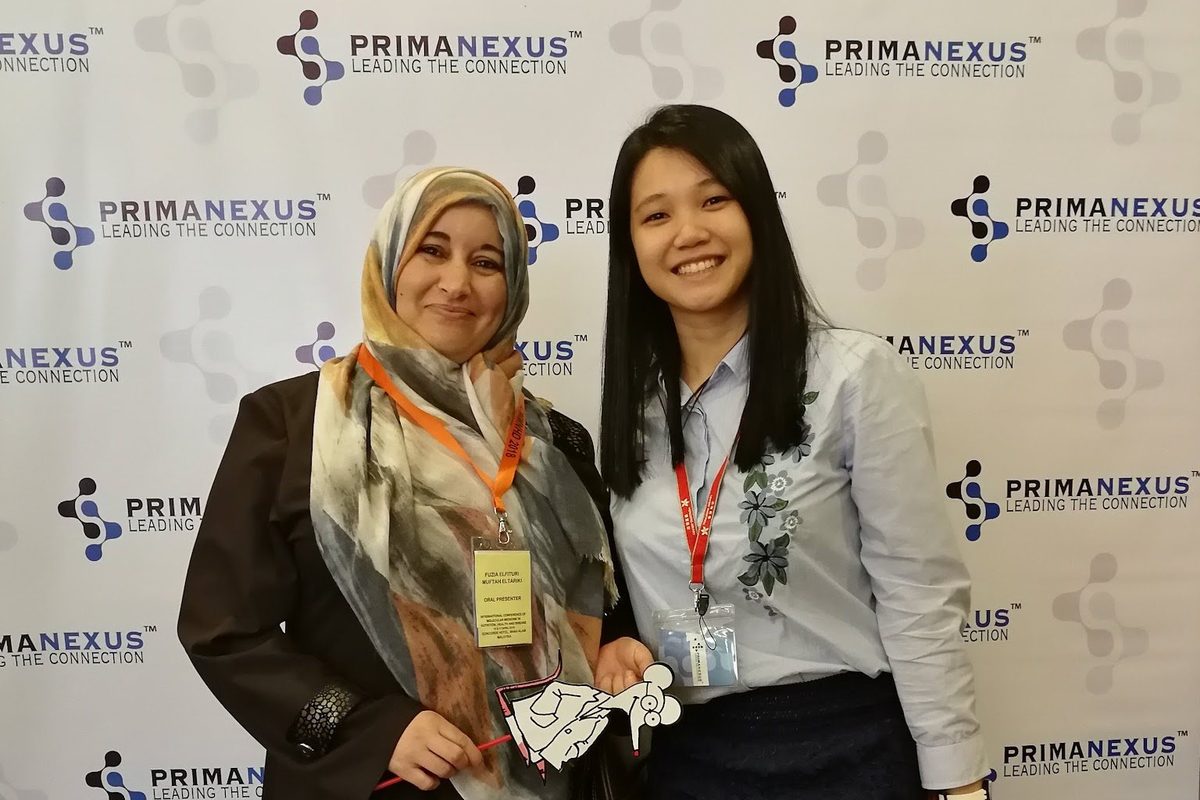Two delegates at the Prima Nexus photo wall