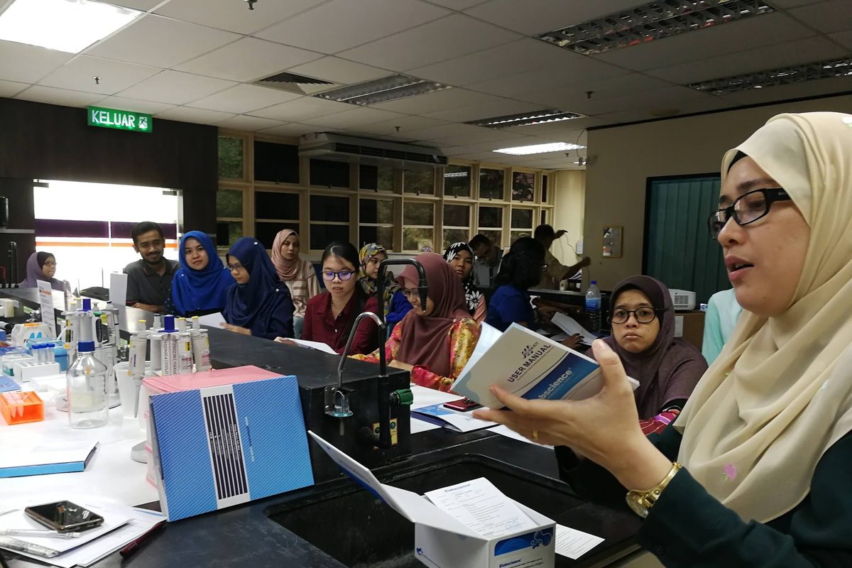 A participant reads the workshop notes at the bench