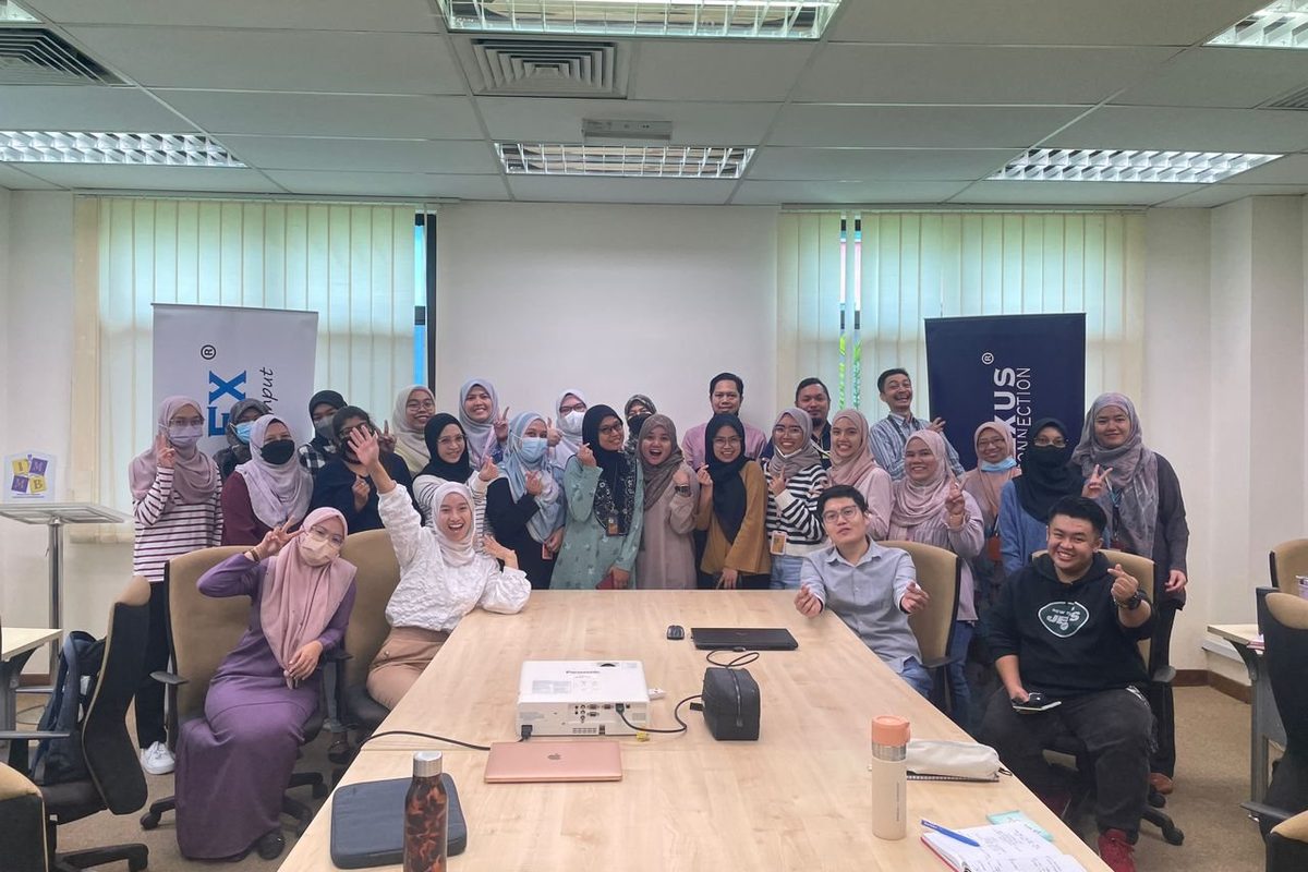 Workshop participants and the Prima Nexus team in a group photo in a meeting room at IMMB