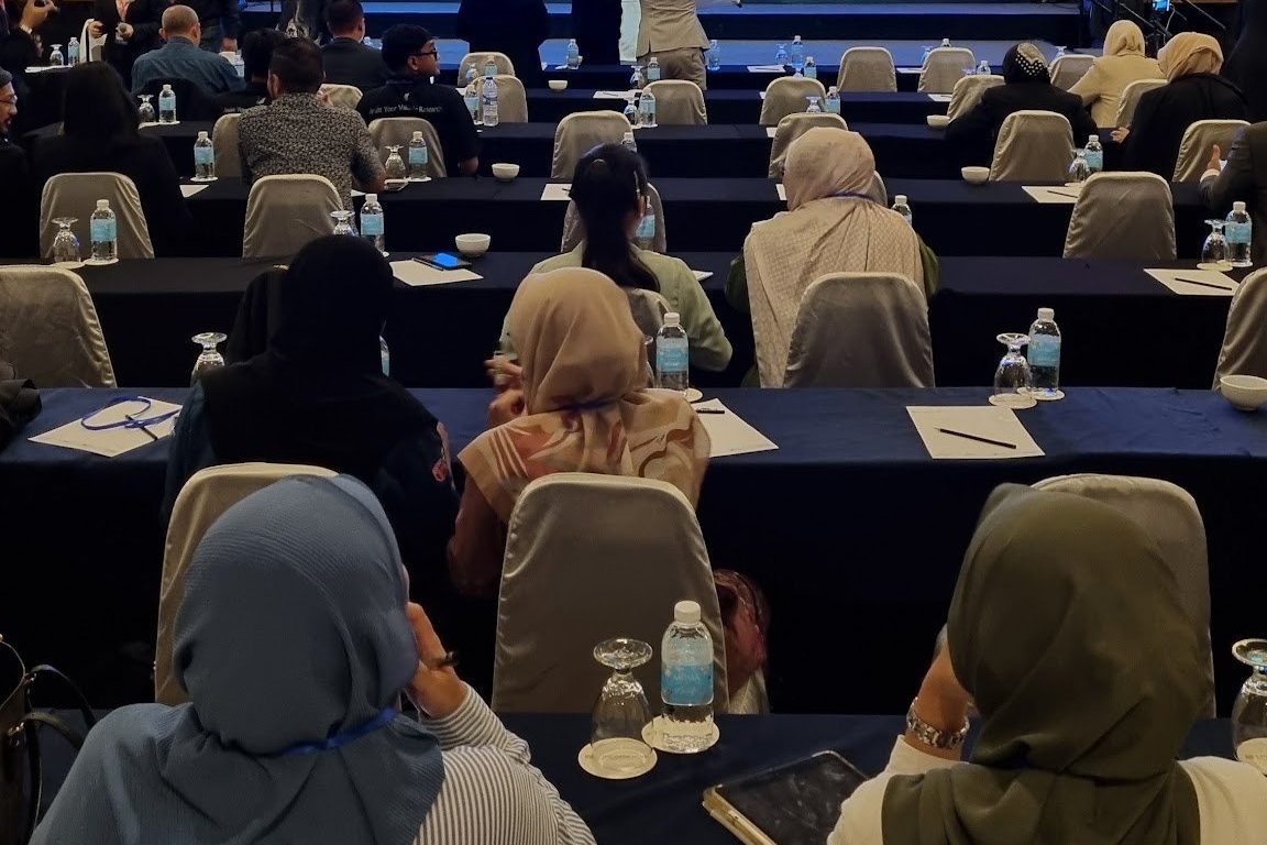 The conference hall during a talk, with participants seated in rows