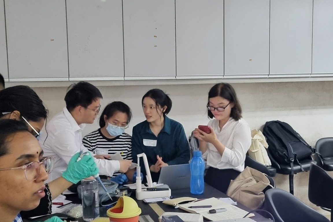 Participants at laboratory benches working through the protocol