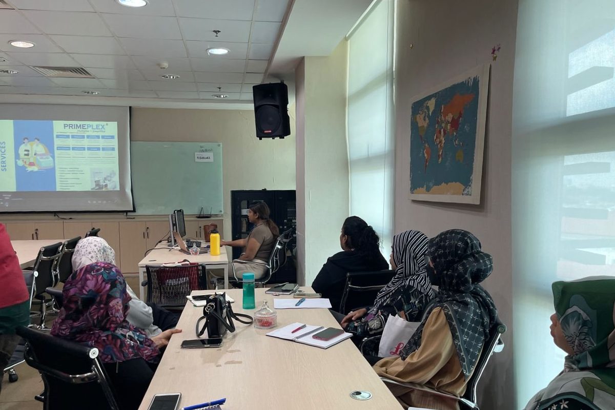 Participants at meeting tables listening to a talk