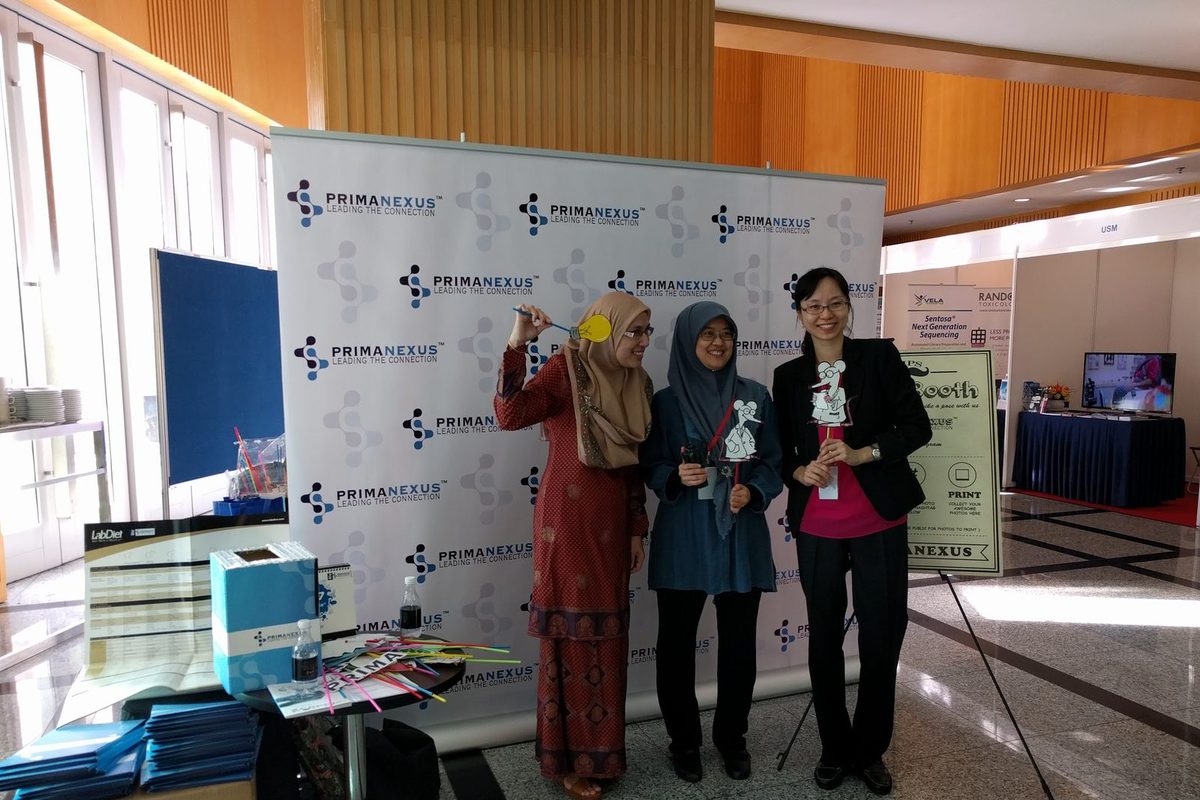 Three delegates with photo props at the Prima Nexus photo booth