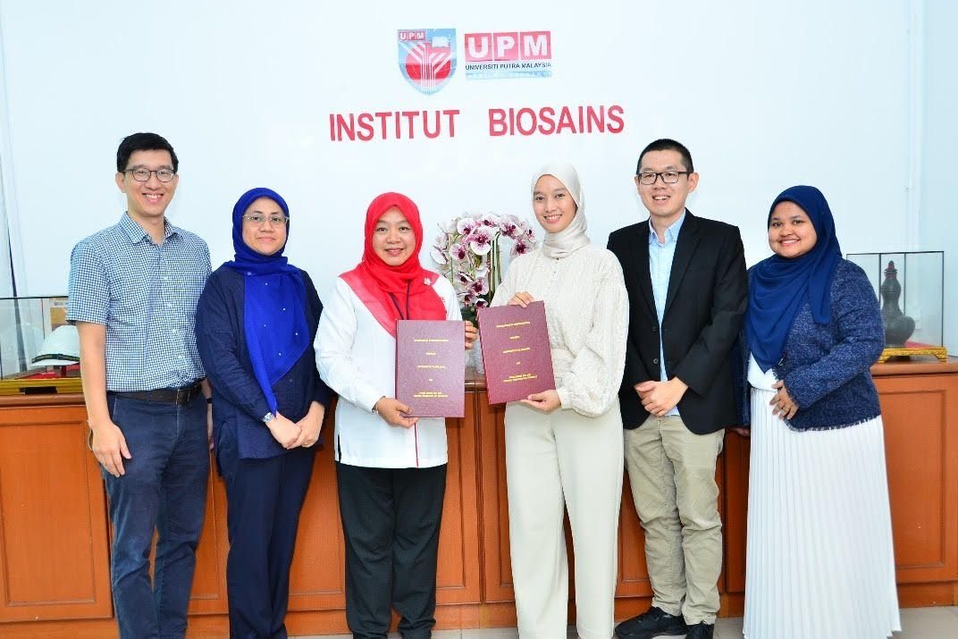 Prima Nexus and UPM Institute of Bioscience representatives holding the renewed MoU documents