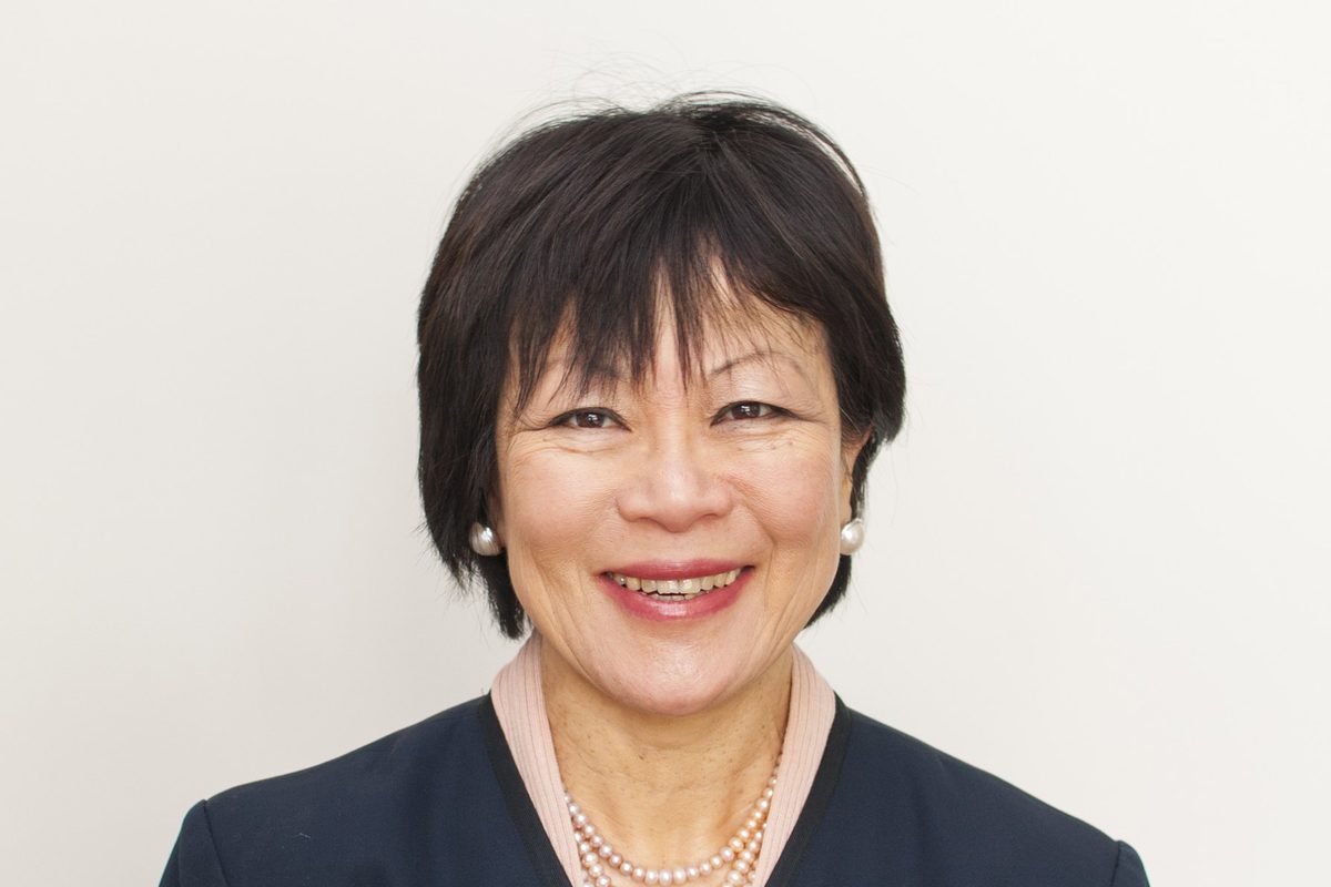 Dr Swee Lay Thein, smiling, in a navy jacket and a pearl necklace