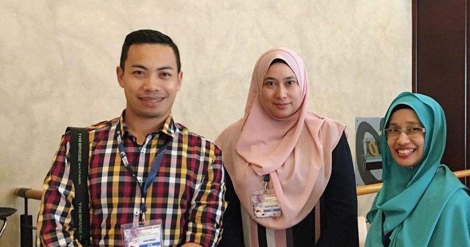 Three conference delegates stand together in the hotel