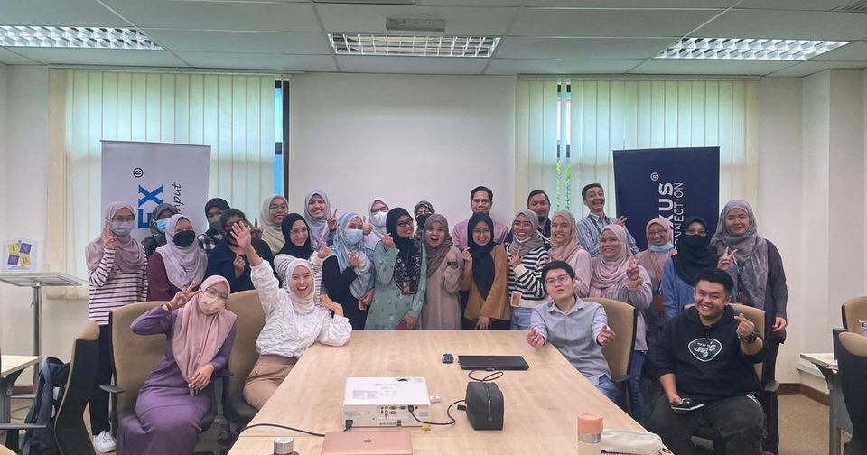 Workshop participants and the Prima Nexus team in a group photo in a meeting room at IMMB