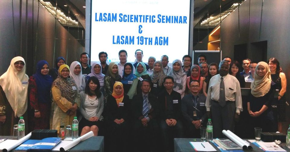 Group photo of participants in front of a screen reading LASAM Scientific Seminar and LASAM 19th AGM