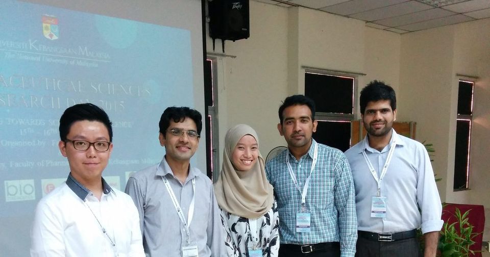 Five people standing in front of the Pharmaceutical Sciences Research Day 2015 title slide