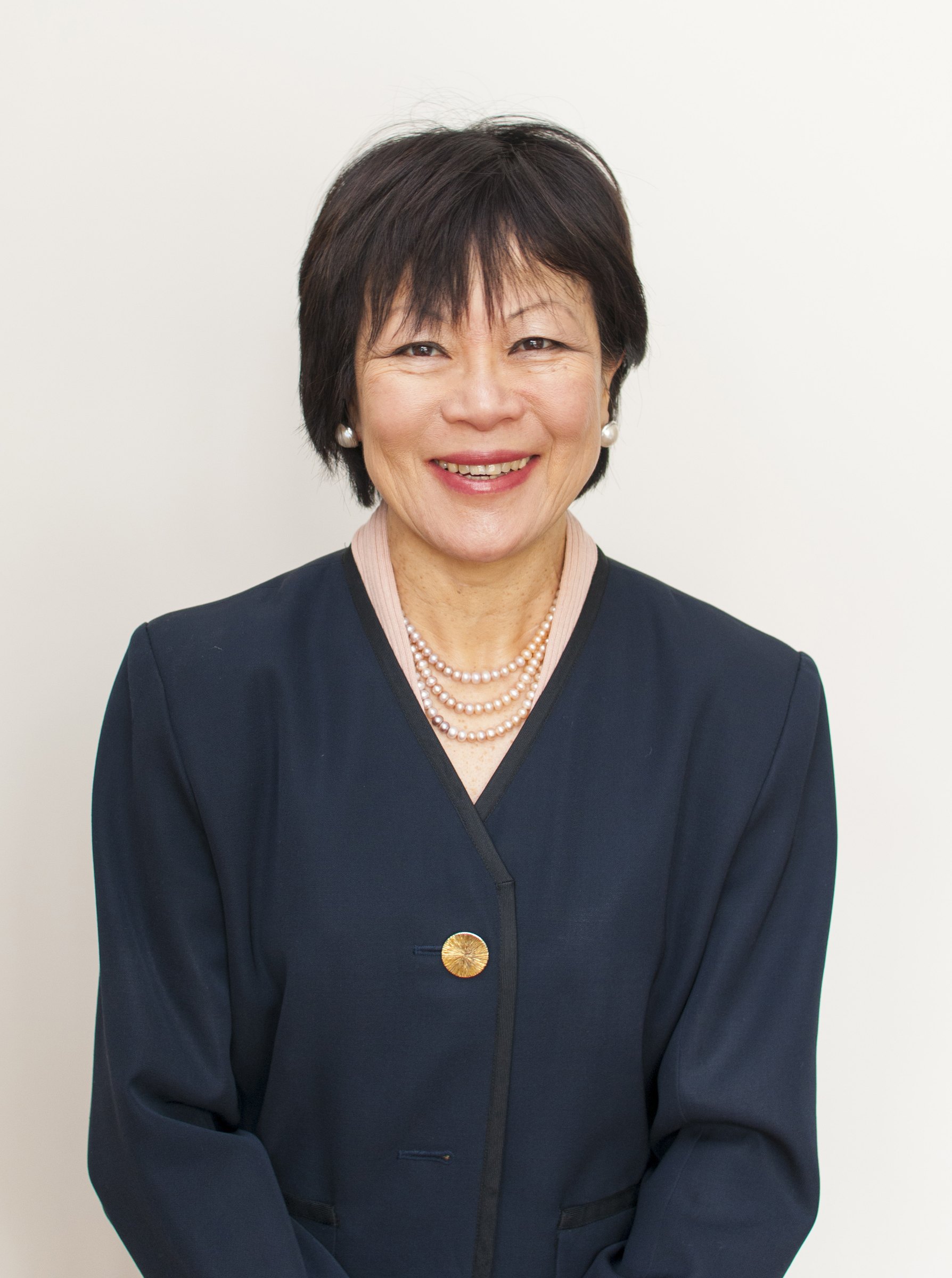 Dr Swee Lay Thein, smiling, in a navy jacket and a pearl necklace