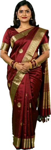 An Indian woman in a maroon and gold saree